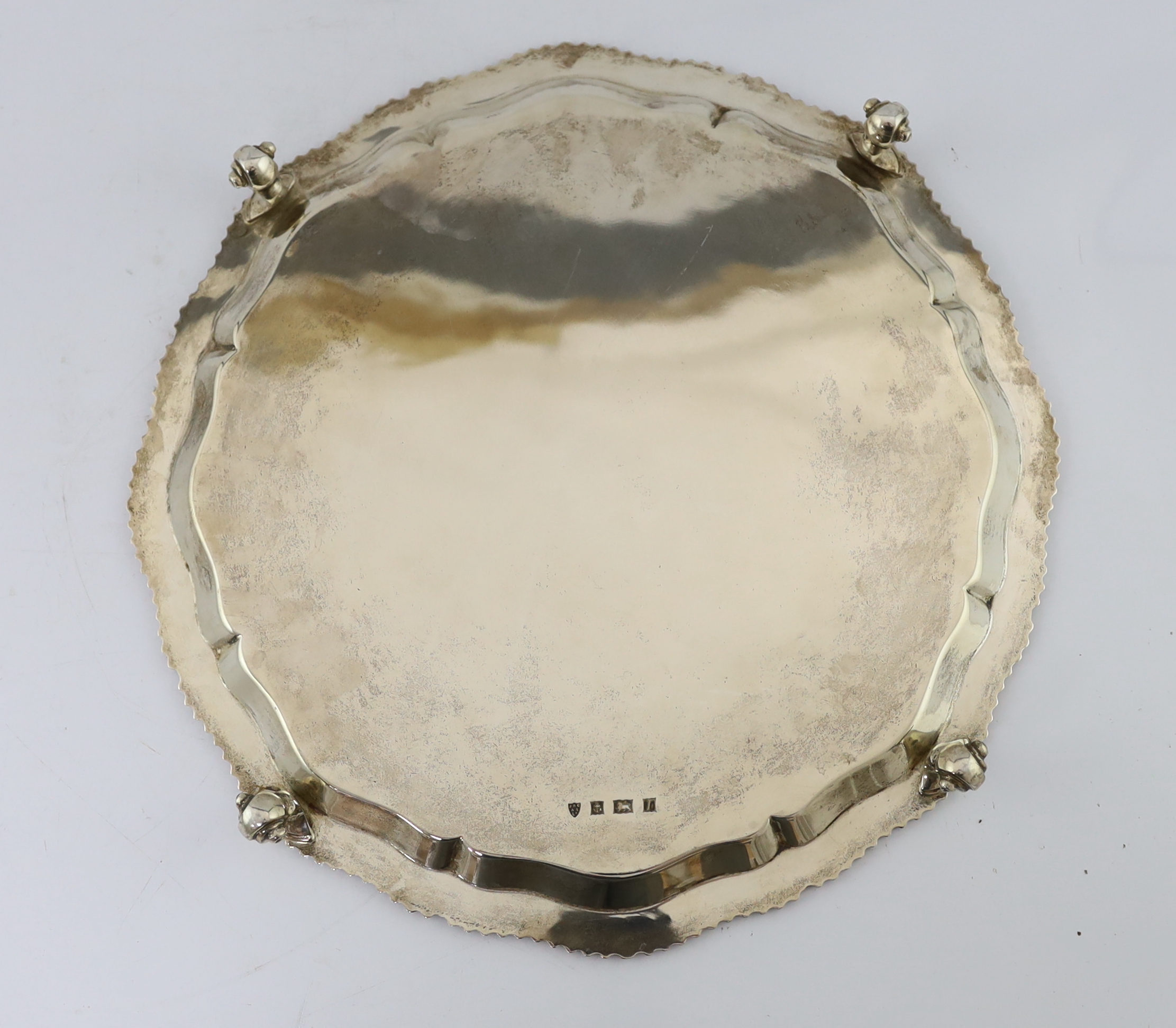 A large Elizabeth II circular silver salver, with piecrust and gadrooned edge, on four scrolled feet, by J.B. Chatterley & Sons Ltd